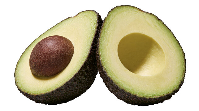 Isolated halves of fresh ripe avocado fruit, one with pit, ready for healthy meal preparation