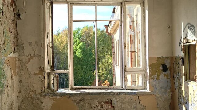 A broken window in a deteriorated building