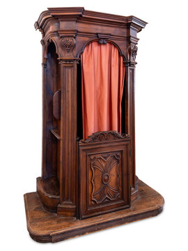 Ancient baroque style ornate wooden confessional booth with red fabric curtain, featuring detailed classical carvings and traditional ebanistry craftsmanship, isolated on white with clipping  path