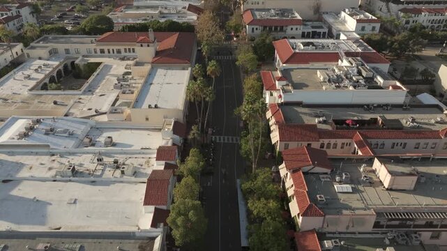 Santa Barbara, California, USA - Face-Down Aerial View of Downtown State Street Promenade With Commercial Buildings, City Streets and Pacific Ocean at Sunset