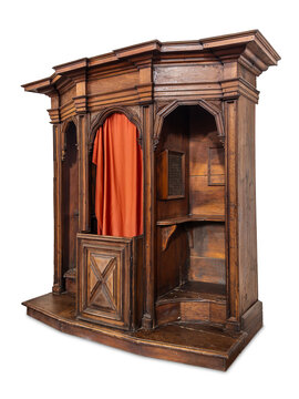 Ancient Baroque style wooden confessional booth from Catholic church, featuring fine classical moldings, central priest compartment with red curtain, isolated on white with clipping path