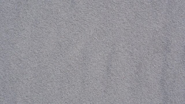 Rotating close-up of beach sand texture, captured from above. Natural patterns evoke time, impermanence, balance, and the philosophy of life.