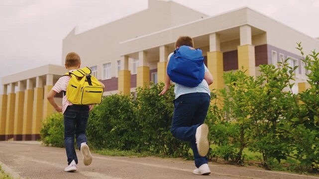 School journey begins, Happy boys in motion, Learning journey starts, Anticipation for class, Backpacks packed with supplies, Friends running together, Steps towards education, Boys in casual outfits