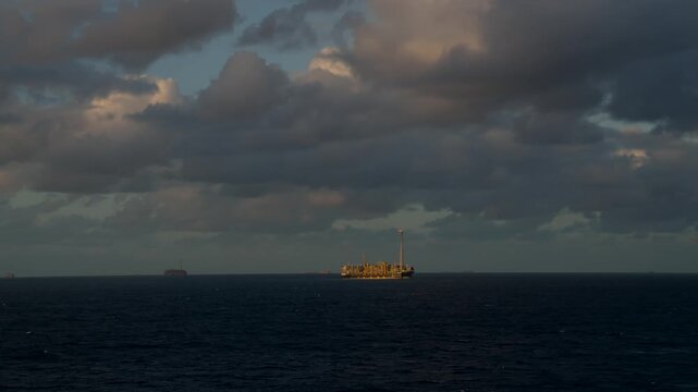 Offshore oil field with multiple FPSOs, oil platforms, and vessels operating at sea. Oil and Gas Industry.