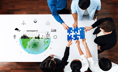 Fototapeta premium A diverse group of professionals collaborates on sustainability initiatives, piecing together solutions illustrated with environmental graphics representing a collective global responsibility. Trope