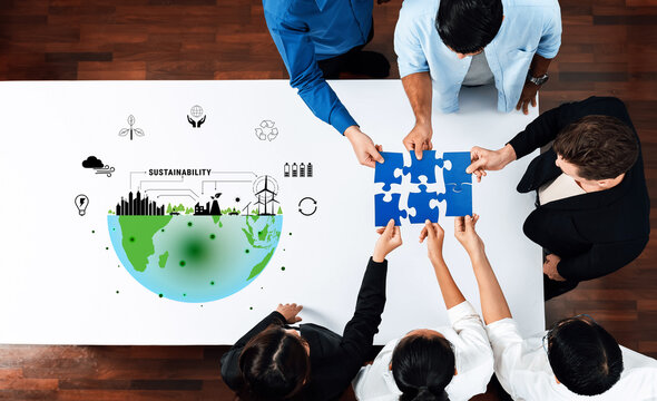 A diverse group of professionals collaborates on sustainability initiatives, piecing together solutions illustrated with environmental graphics representing a collective global responsibility. Trope