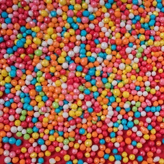 Colorful sugar sprinkles texture on red, full frame © Diana Vyshniakova