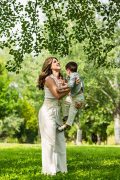 Mother and son bonding playing outdoors in park