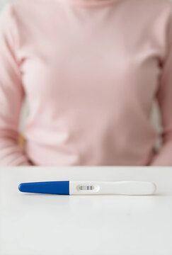Pregnancy test with positive result, family planning and fertility concept, woman waiting for medical news at home with anticipation and anxiety