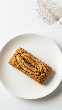 Gourmet Malagasy Koba Akondro Caramelized Banana Peanut Loaf on White Ceramic with Copy Space