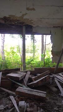 Inside a burnt-out wooden house. Charred walls and remnants of structures inside the building.