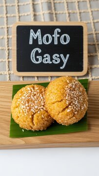 Traditional Malagasy Mofo Gasy Sweet Rice Cakes with Chalkboard Sign on Raw Oak and Banana Leaf