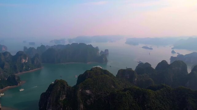 Horizon of Halong Bay: A high altitude daytime panning drone shot over the expansive karst mountain archipelago in Vietnam
