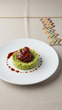 Gourmet Malagasy Ravitoto Cassava Leaf Puree with Confit Zebu Cheek on Beige Linen with Copy Space