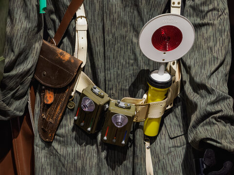 Detail of soldier equipment in a needle pattern camouflage uniform for traffic control.