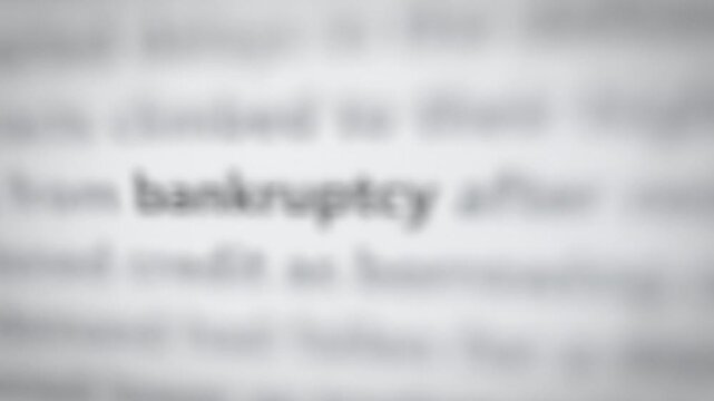 Seamless loop bankruptcy word in news articles focus montage