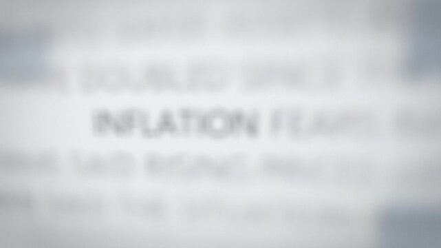 Seamless loop inflation word in news articles focus montage