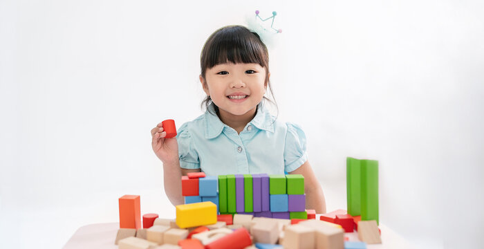 Portrait of asian  little girl toddler children playing blocks in classroom. Learning by playing education group study concept International pupils do activities brain training in primary school