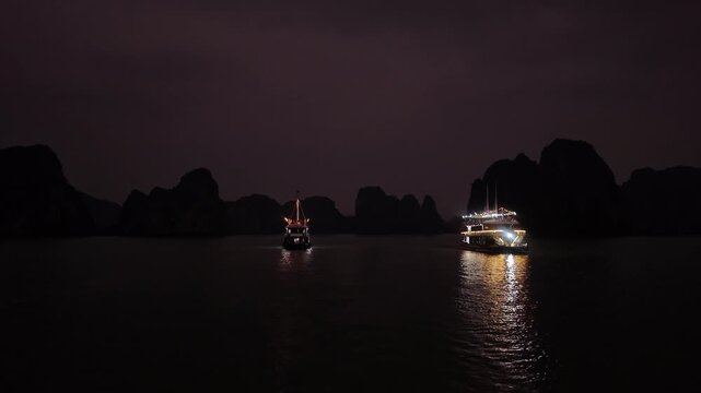 Neon Tides of Halong Bay: A nighttime steady shot revealing illuminated cruise ships navigating through dark limestone islands in Vietnam
