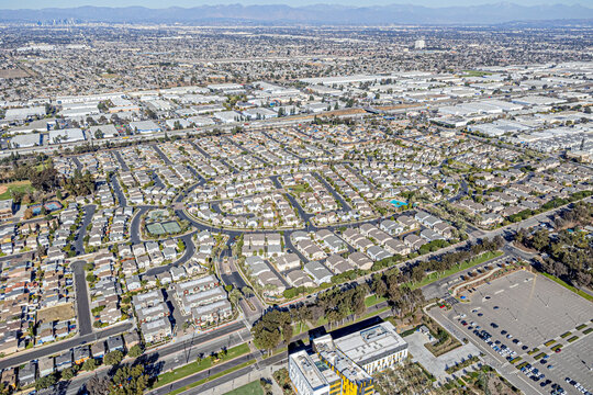 Carson, California, CA January 14, 2025: High Aerial Drone Photo View toward Central Ave, Victoria St, Freeway 91 with Hometown, Community, Streets, Homes, Houses, Sky, Mountain, Sunny Day


