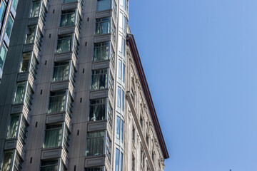 Historic building corner facade against clear blue sky © kodai