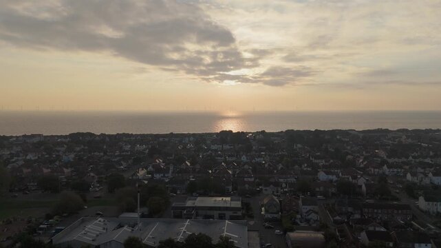 Soft golden light bathes coastal town at dusk