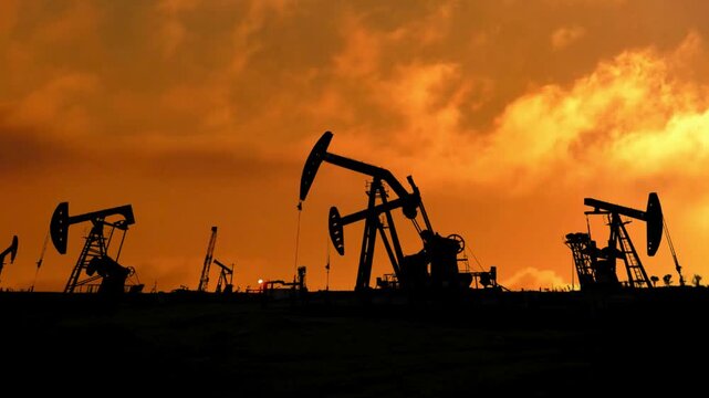 Oil Rig With Moving Cloud Background. Oil drilling derricks at desert oilfield. Crude oil production from the ground.