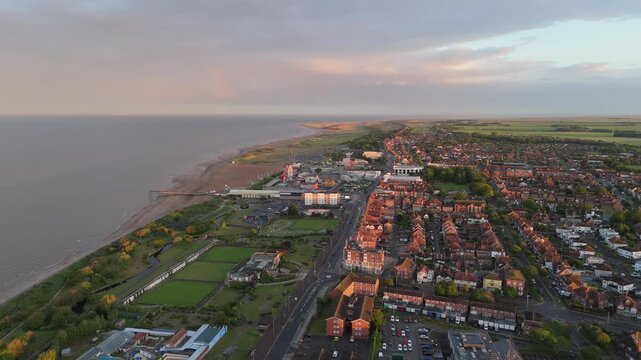 Sunset bathes seaside town in soft, golden glow