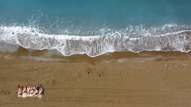Top view of people sunbathing on beach