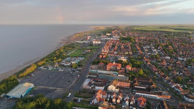 Golden light bathes coastal town at dawn