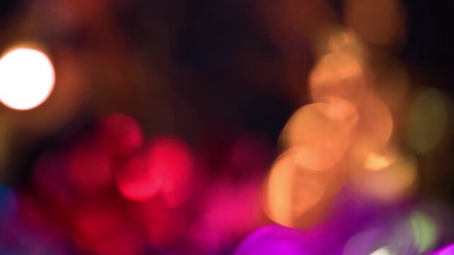 Abstract blurry colorful light leaks and bokeh effect against dark background