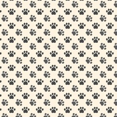 Seamless pattern of dark grey animal paw prints on a light cream background © Dina A