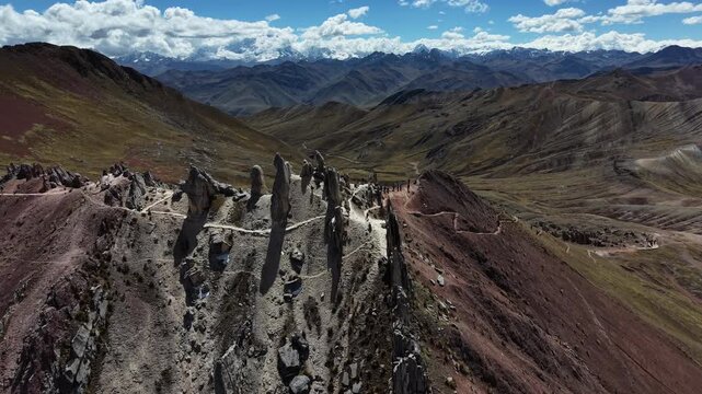 Cinematic aerial drone footage of Palcoyo Mountain in the Peruvian Andes, capturing the rugged high-altitude landscape and colorful mountain terrain from above the hiking trail.