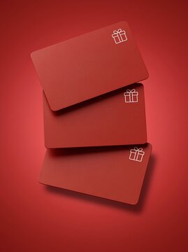 Three blank red gift cards with white icons on a red background