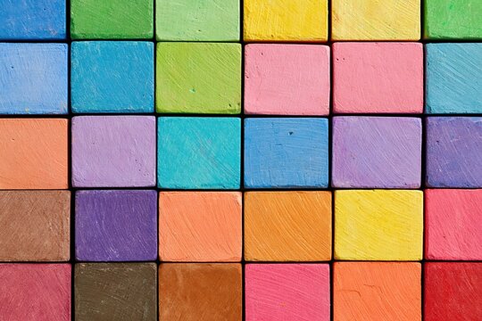 Chalk pastel sticks in a vibrant rainbow grid pattern for art drawing supplies and color pigment