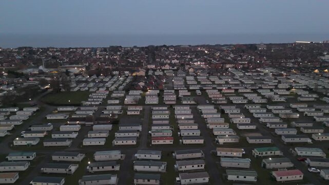 Aerial view shows rows of mobile homes at dusk