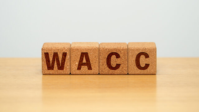 WACC on four cork wooden blocks - weighted average cost of capital concept