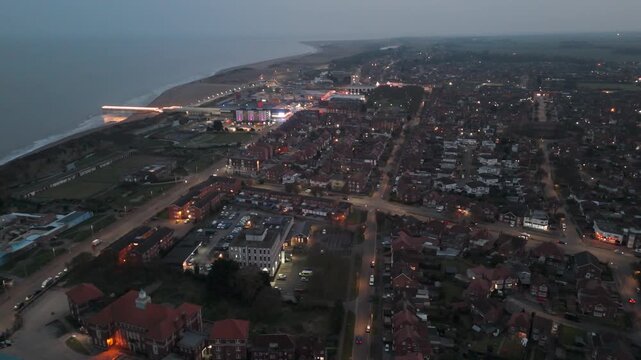 Dusk settles over coastal town with glowing streets