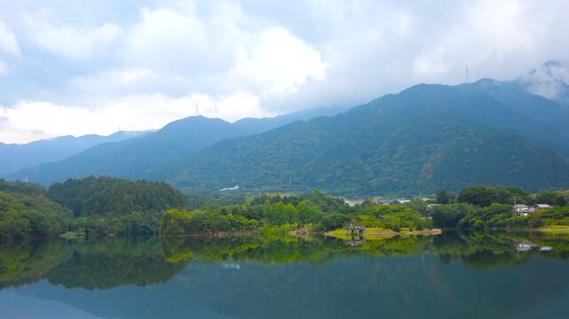 Emerald Blue Pond Reflection of Mountains and Sky at Ikeda Pond Niihama Ehime Japan