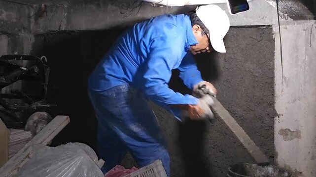Mason Leveling Wet Plaster Wall With Wooden Screed Straightedge