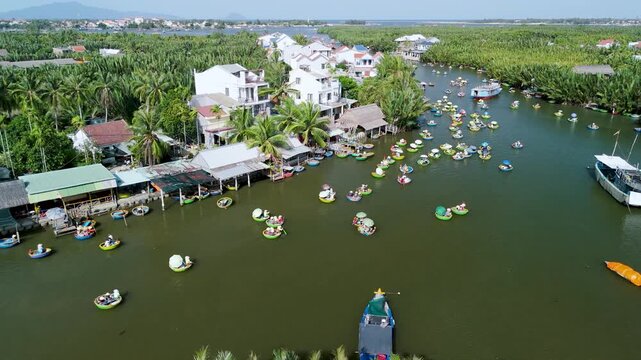 Numerous colorful basket boats drift slowly along the winding river