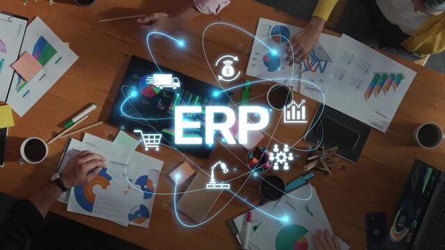 Aerial view of a team engaging in collaborative planning around a wooden table, showcasing the concept of ERP with digital icons, charts, and brainstorming materials. Raster