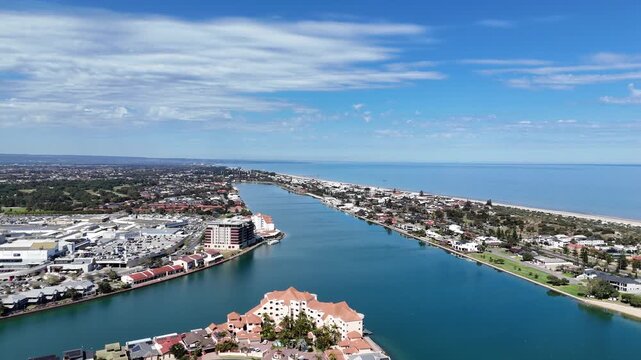 Aerial drone view of West Lakes, Adelaide, South Australia, Australia, with a large shopping complex, upscale coastal homes and the open blue ocean. Beautiful urban living environment.