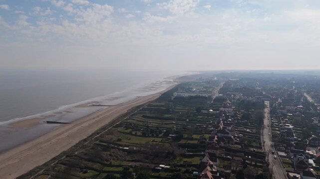 Aerial view of wide sandy beach with gentle waves