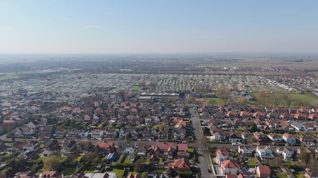 Aerial view of suburban homes under clear blue sky
