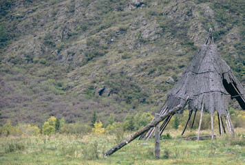 Traditional wooden wigwam dwelling made of bark in mountains © VKirillov