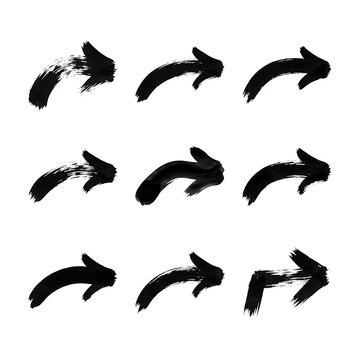 Hand drawn ink brush arrows set, expressive black paint strokes isolated on white background for graphic design