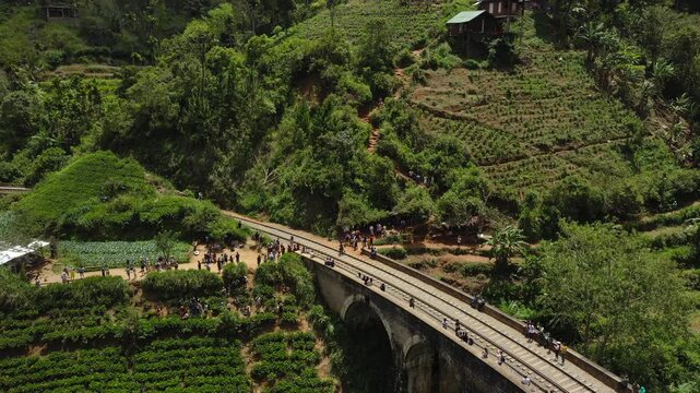 Nine Arches Bridge in Sri Lanka with Tourists and Lush Greenery Aerial