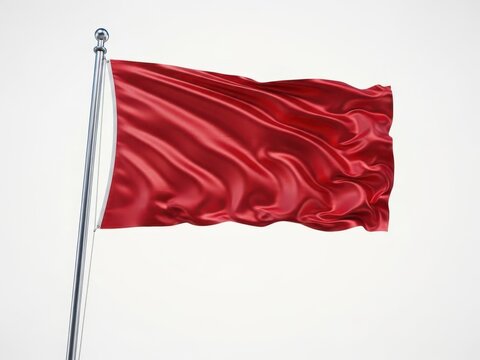 Red waving flag on metal pole against plain background