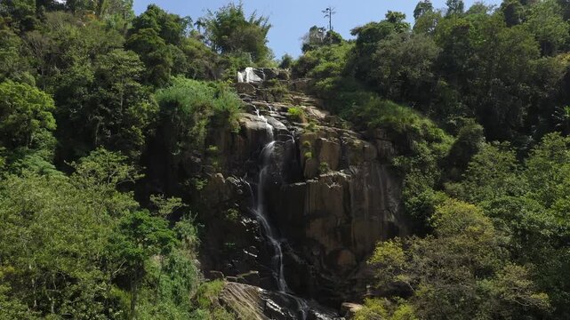 Waterfall Cascading Down Rocky Cliff in a Lush Sri Lankan Jungle